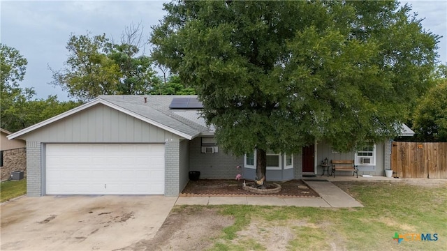1003 Tyler Dr, Copperas Cove, TX 76522 - view of front of home featuring brick siding, an attached garage, solar panels, and concrete driveway