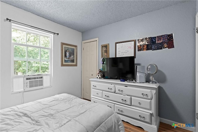 1003 Tyler Dr, Copperas Cove, TX 76522 - bedroom with a textured ceiling, dark wood-style flooring, and cooling unit