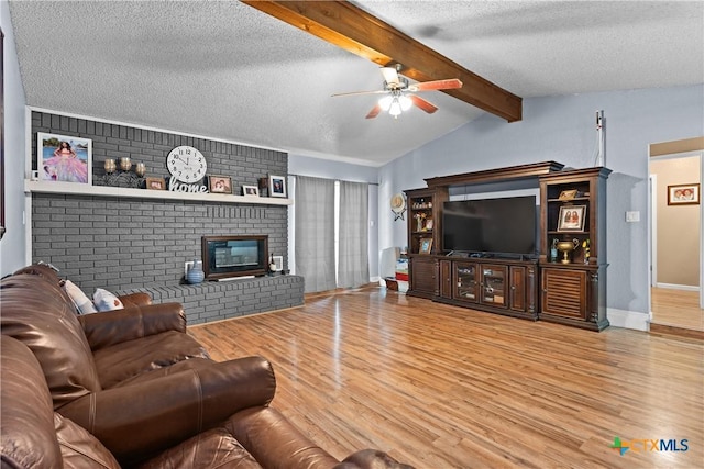 1003 Tyler Dr, Copperas Cove, TX 76522 - living area featuring a ceiling fan, a textured ceiling, wood finished floors, and a fireplace