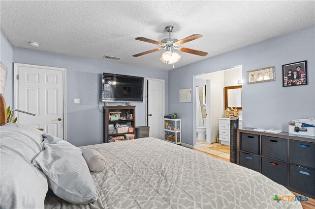 1003 Tyler Dr, Copperas Cove, TX 76522 - bedroom featuring a textured ceiling, ceiling fan, and connected bathroom