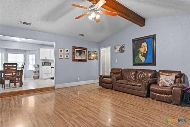 1003 Tyler Dr, Copperas Cove, TX 76522 - living room with light wood finished floors, ceiling fan, and a textured ceiling
