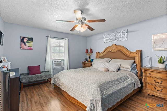 1003 Tyler Dr, Copperas Cove, TX 76522 - bedroom featuring wood finished floors, cooling unit, a textured ceiling, and a ceiling fan