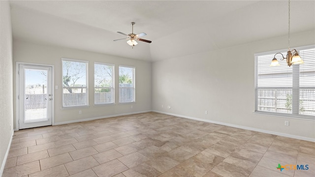 unfurnished room with lofted ceiling, ceiling fan with notable chandelier, and plenty of natural light