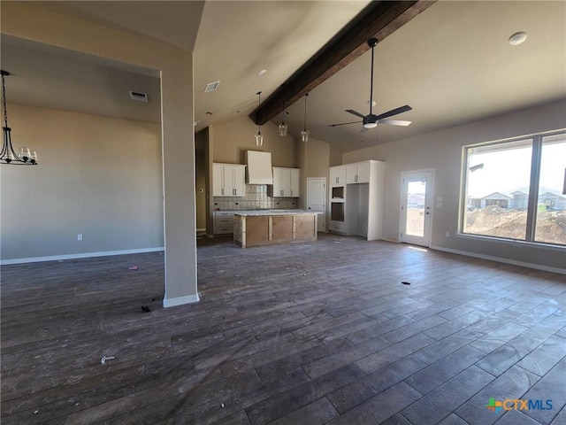 unfurnished living room featuring beam ceiling, ceiling fan with notable chandelier, high vaulted ceiling, and dark wood-type flooring