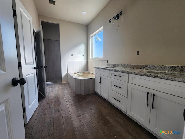 bathroom with independent shower and bath, vanity, and wood-type flooring