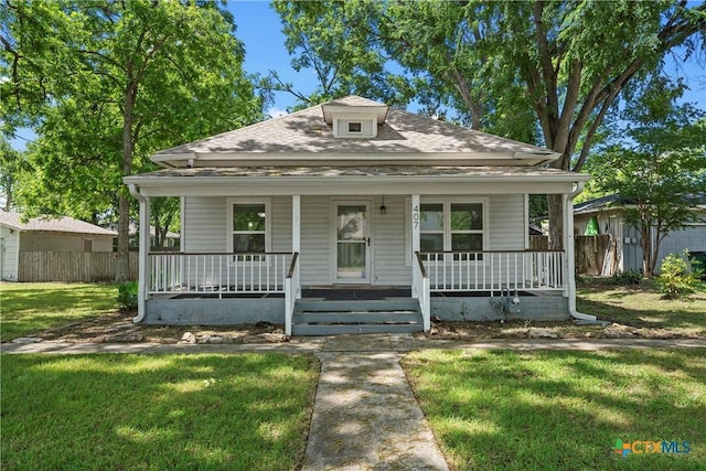 bungalow-style home featuring a porch and roof with shingles