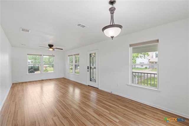 unfurnished living room featuring a ceiling fan, light wood finished floors, and baseboards