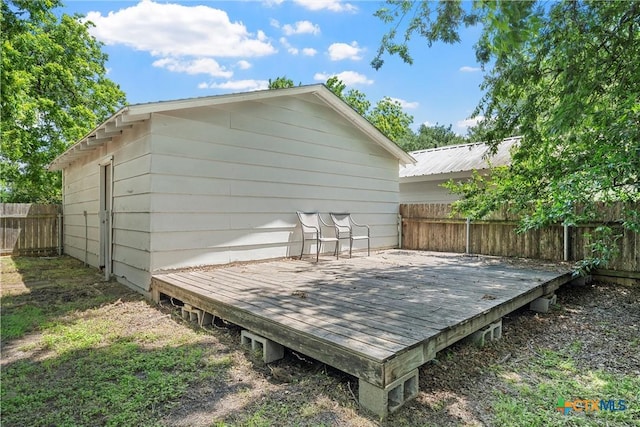 wooden deck with a fenced backyard