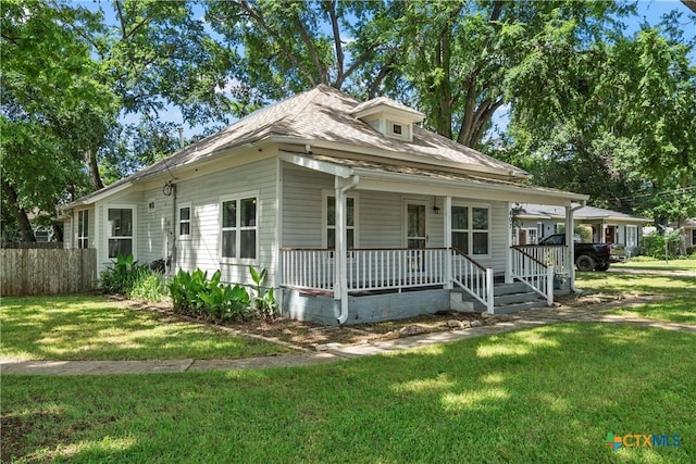 view of front facade with covered porch and roof with shingles