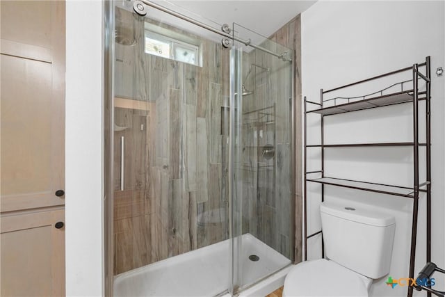 full bath with toilet and a shower stall