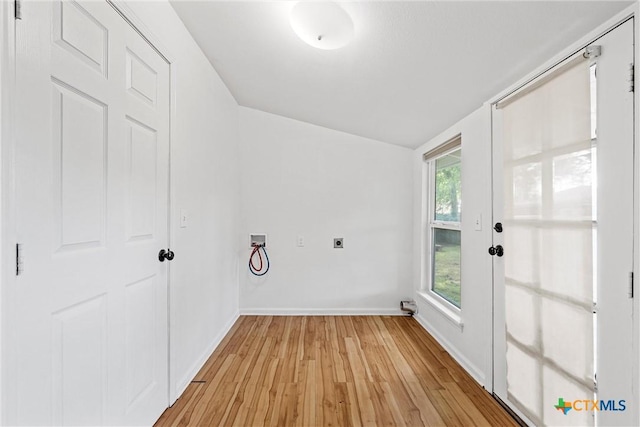 washroom featuring hookup for an electric dryer, hookup for a washing machine, light wood-type flooring, baseboards, and french doors