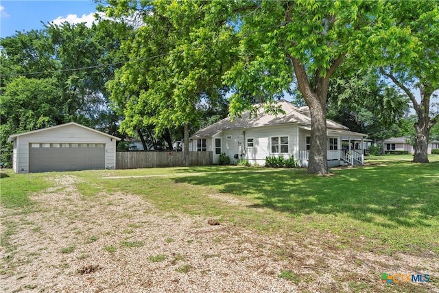ranch-style house with a porch, a detached garage, and an outdoor structure