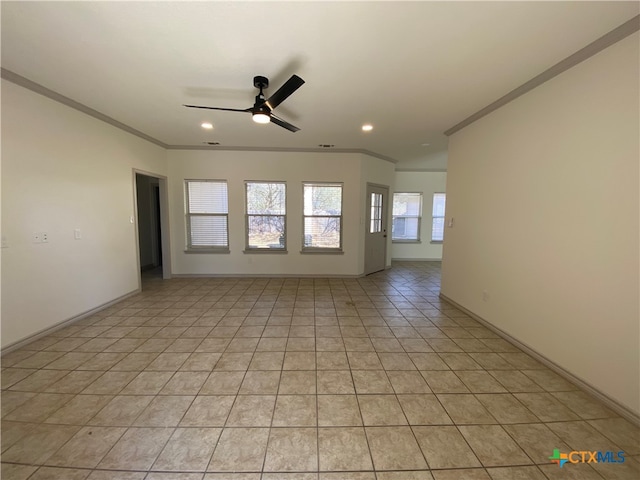 tiled empty room with ceiling fan and crown molding