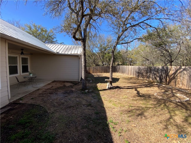 view of yard featuring a patio area and ceiling fan