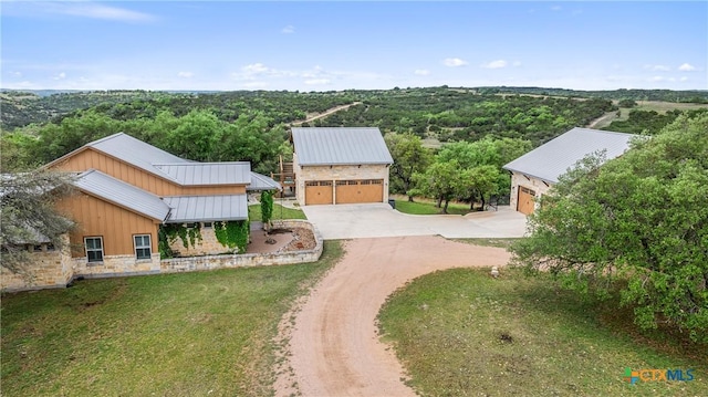 drone / aerial view with a wooded view