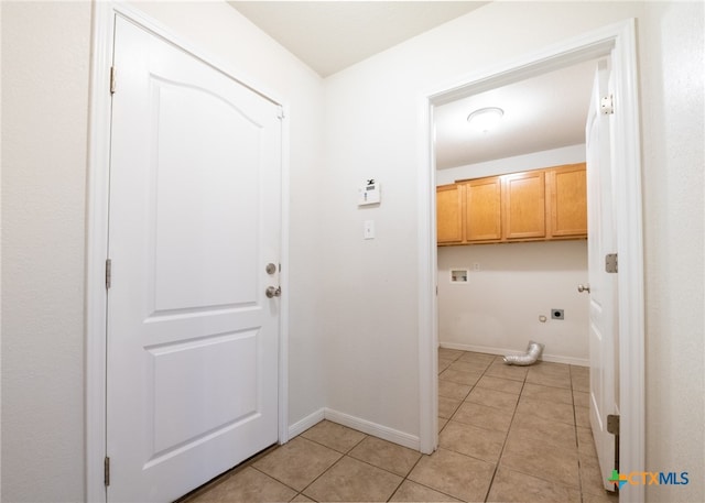 laundry area featuring hookup for an electric dryer, hookup for a washing machine, cabinets, and light tile patterned floors