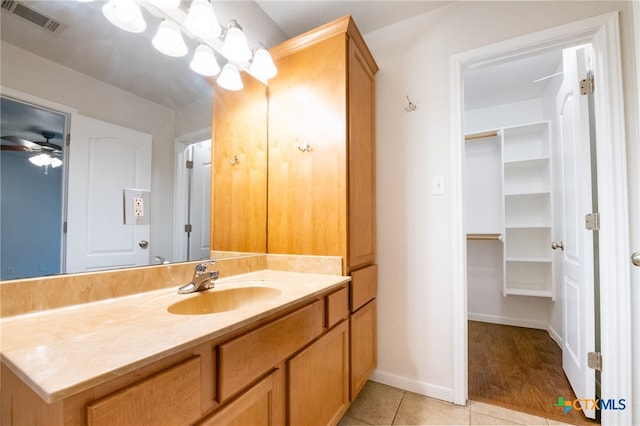 bathroom with vanity, ceiling fan, and tile patterned flooring