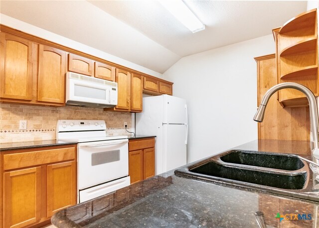 kitchen featuring dark stone counters, decorative backsplash, sink, vaulted ceiling, and white appliances