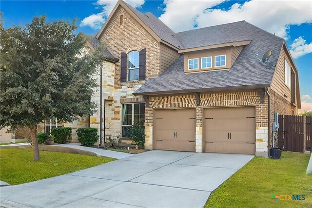 view of front of property with a front lawn and a garage