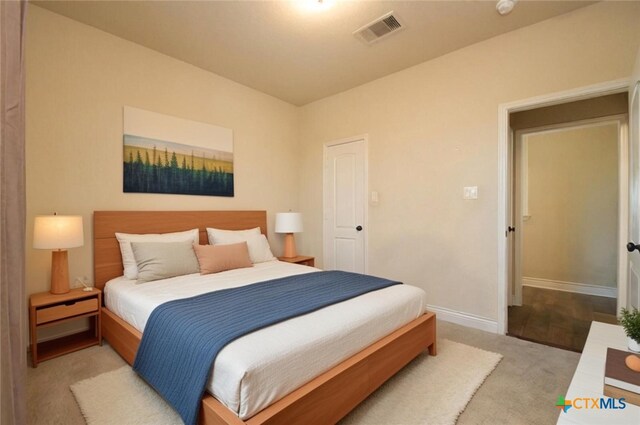 bedroom featuring light colored carpet