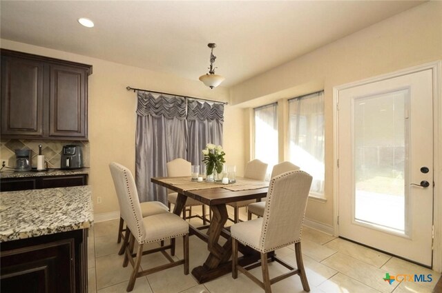 dining space with a healthy amount of sunlight and light tile patterned flooring