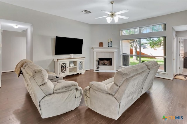 722 Ashland Crk, Victoria, TX 77901 - living room featuring ceiling fan, dark wood-style floors, and a fireplace