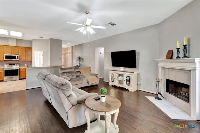 722 Ashland Crk, Victoria, TX 77901 - living room with wood finished floors, ceiling fan, and a fireplace