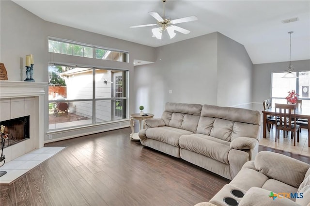 722 Ashland Crk, Victoria, TX 77901 - living room with a ceiling fan, light wood-style flooring, a fireplace, healthy amount of natural light, and vaulted ceiling
