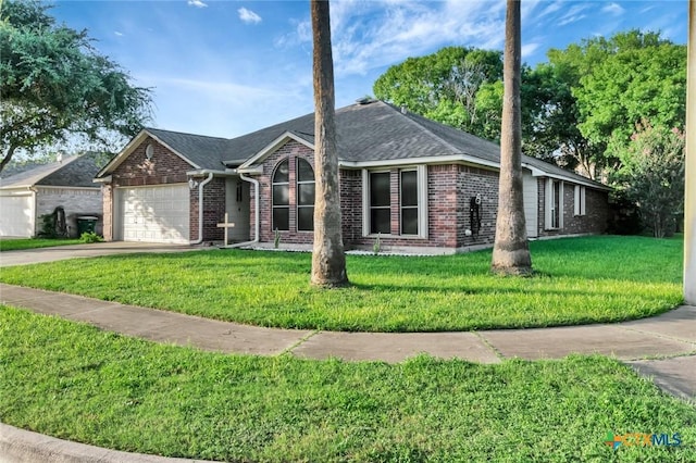 722 Ashland Crk, Victoria, TX 77901 - ranch-style house with brick siding, an attached garage, driveway, and a front lawn