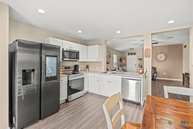 kitchen with white cabinetry, appliances with stainless steel finishes, sink, and wood-type flooring