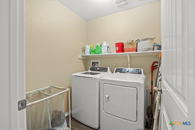 laundry area featuring hardwood / wood-style flooring and washer and dryer