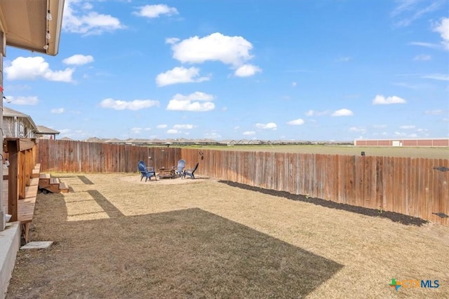 view of yard with an outdoor fire pit