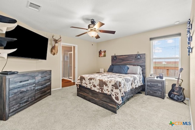 bedroom featuring ensuite bathroom, ceiling fan, and light carpet