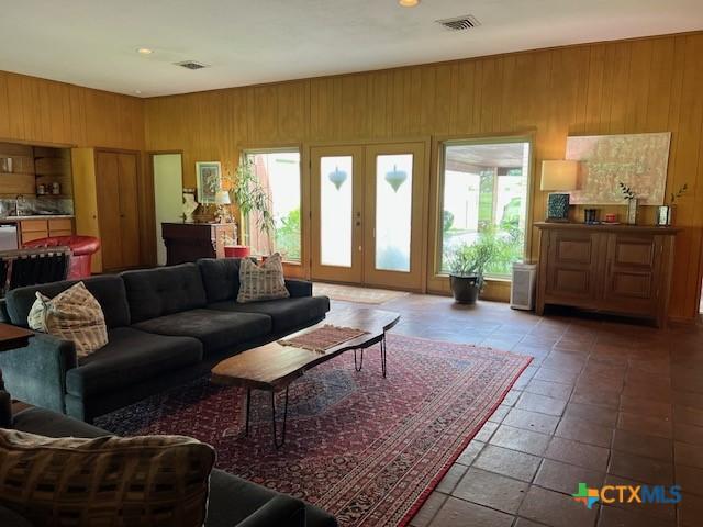 6014 Country Club Dr, Victoria, TX 77904 - living room with visible vents, recessed lighting, and wooden walls