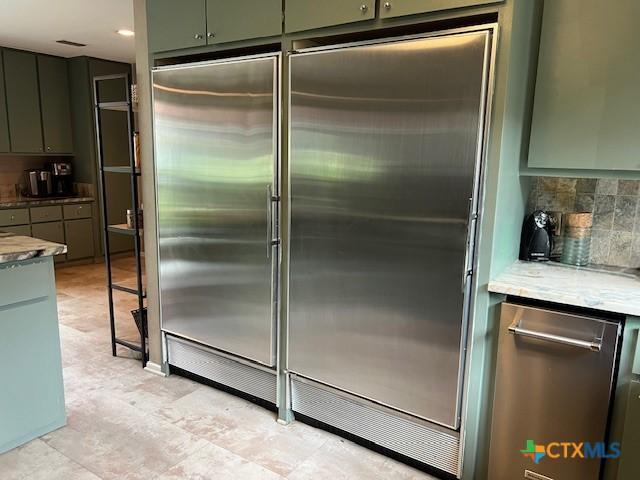 6014 Country Club Dr, Victoria, TX 77904 - kitchen featuring backsplash, built in refrigerator, and green cabinets