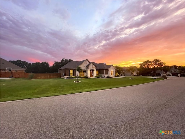 view of front of home featuring a front yard and fence