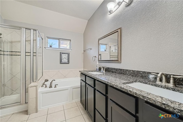 bathroom featuring tile patterned flooring, vanity, separate shower and tub, and vaulted ceiling