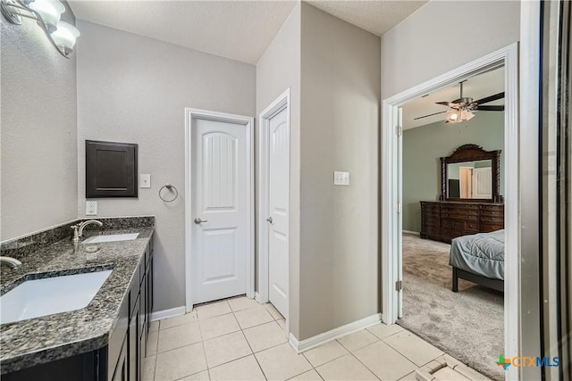 bathroom with a textured ceiling, vanity, tile patterned floors, and ceiling fan