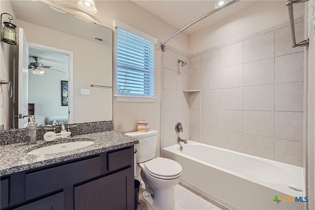 full bathroom featuring tile patterned floors, vanity, ceiling fan, toilet, and tiled shower / bath