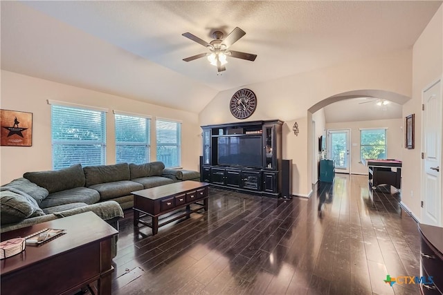 living room featuring dark hardwood / wood-style flooring, vaulted ceiling, and ceiling fan