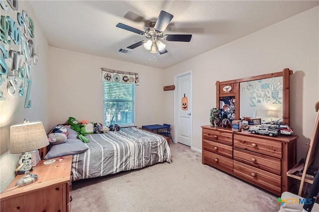 bedroom featuring ceiling fan and light colored carpet