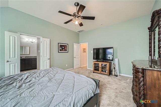 carpeted bedroom featuring ensuite bath, ceiling fan, and vaulted ceiling