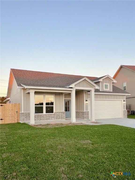 ranch-style home with a porch, a garage, and a front lawn