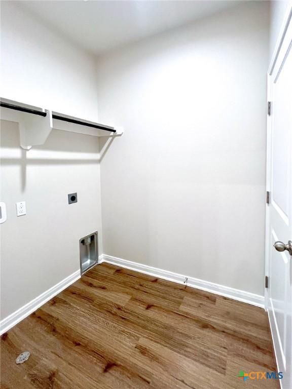 laundry area with hardwood / wood-style flooring and electric dryer hookup