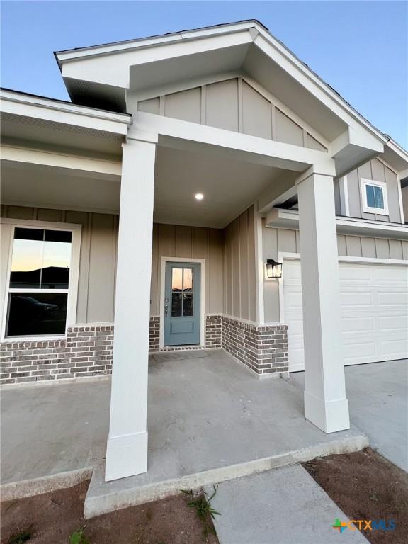 view of exterior entry featuring a garage