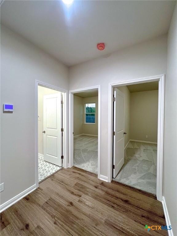 corridor with light hardwood / wood-style floors