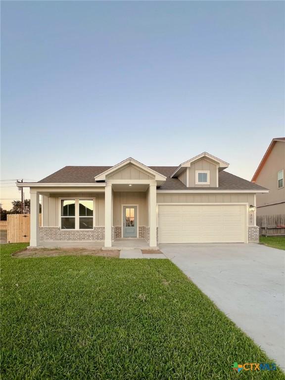 view of front of house with a garage and a front lawn