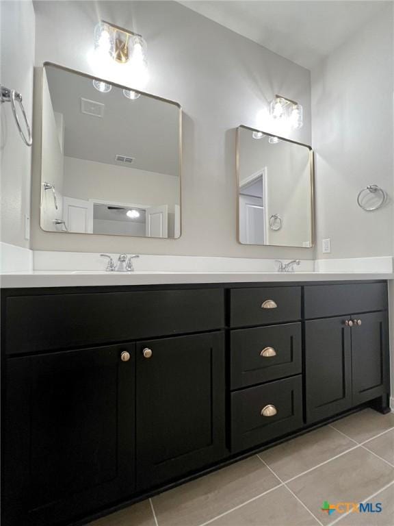 bathroom featuring tile patterned flooring and vanity