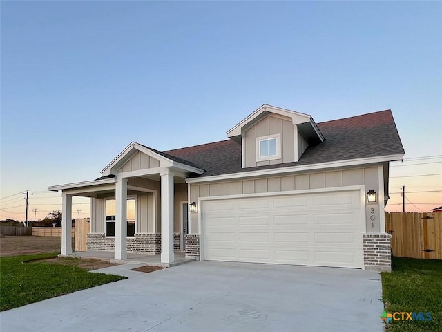 view of front facade with a porch and a garage