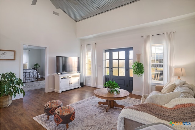 living room with high vaulted ceiling and dark hardwood / wood-style floors